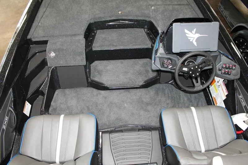 Slide: The Image of 2026 Skeeter ZXE21 boat interior with steering wheel, dashboard, and seating. - 9