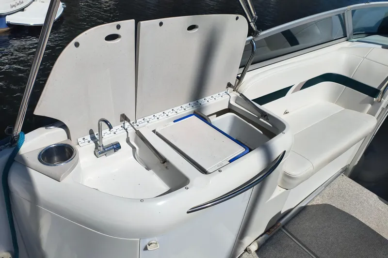 Slide: The Image of 2003 Formula 260 Sun Sport boat docked, featuring spacious seating and green canopy. - 15