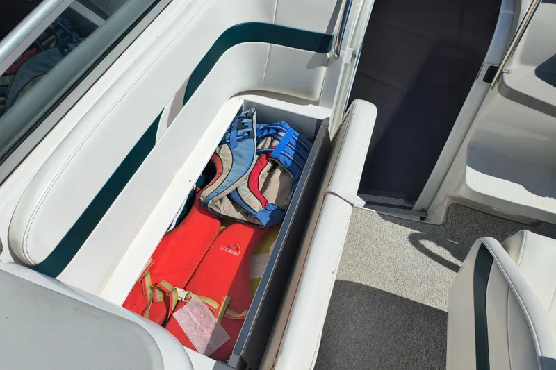 Slide: The Image of 2003 Formula 260 Sun Sport boat interior with white seating and steering console. - 18