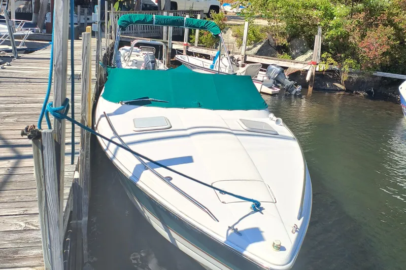 Slide: The Image of 2003 Formula 260 Sun Sport boat docked with green cover, sunny day. - 2