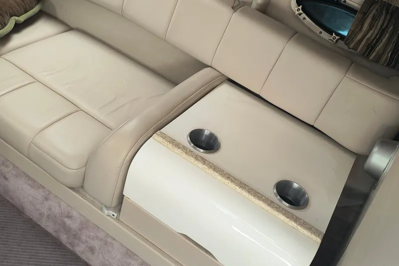 Slide: The Image of 2003 Formula 260 Sun Sport boat interior with open storage compartment and blue cooler. - 24