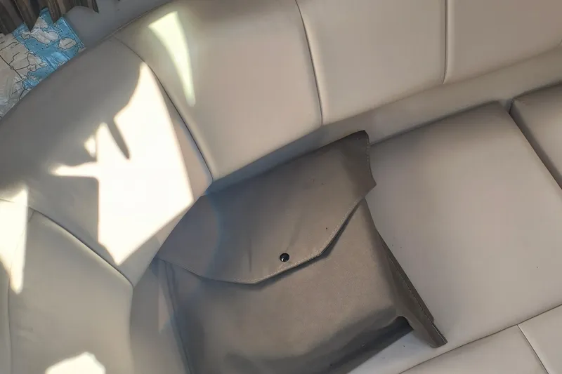 Slide: The Image of 2003 Formula 260 Sun Sport boat interior with white seating and teal accents. - 25