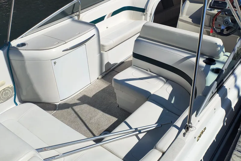 Slide: The Image of 2003 Formula 260 Sun Sport boat interior with white seating and stainless steel handrails. - 9