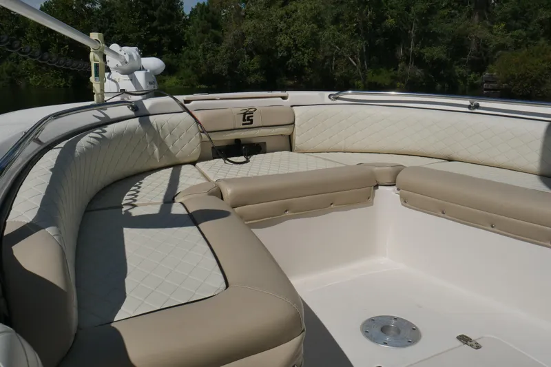 Slide: The Image of 2022 Carolina Skiff 23 Ultra Elite boat interior with cushioned seating and stainless steel railing. - 12