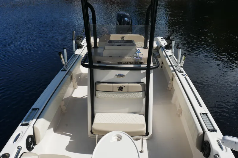 Slide: The Image of 2022 Carolina Skiff 23 Ultra Elite boat interior with seating and console on water. - 15