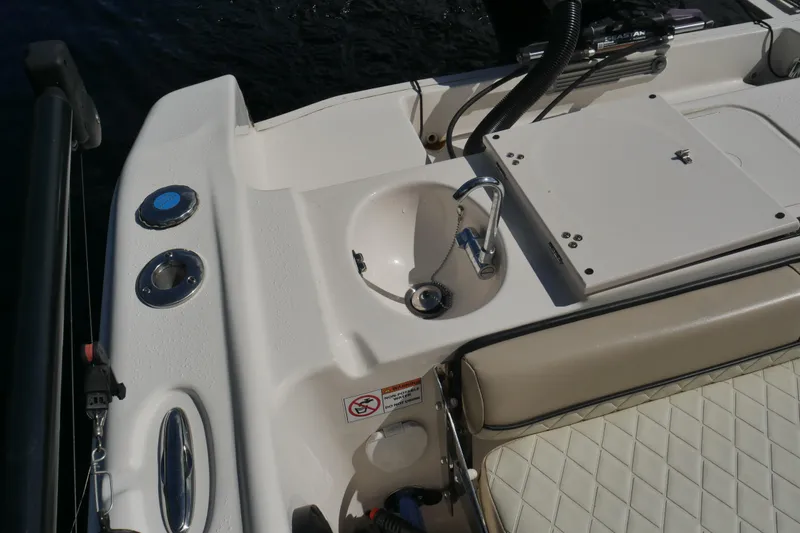 Slide: The Image of 2022 Carolina Skiff 23 Ultra Elite boat sink and seating area detail. - 18