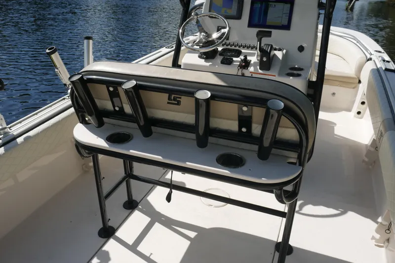 Slide: The Image of 2022 Carolina Skiff 23 Ultra Elite boat interior with rod holders and steering console. - 30