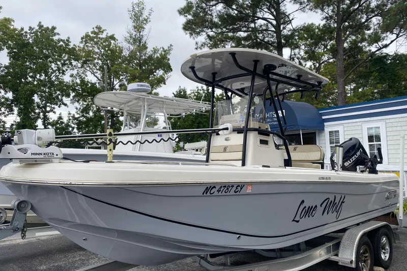 Slide: The Image of 2022 Carolina Skiff 23 Ultra Elite boat on trailer, featuring "Lone Wolf" text. - 33