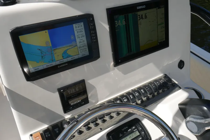 Slide: The Image of Dashboard of 2022 Carolina Skiff 23 Ultra Elite with Garmin and Simrad displays. - 9