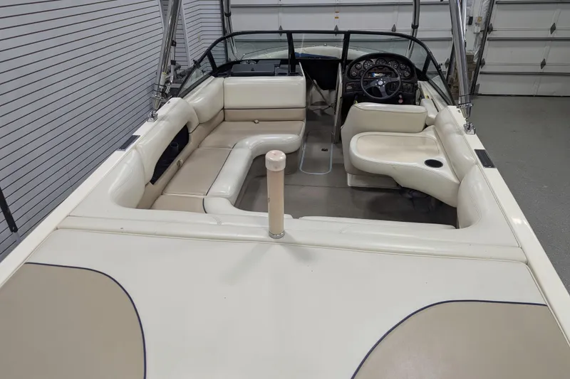 Slide: The Image of 1998 Malibu Sunsetter VLX boat interior with beige seating and steering console. - 11