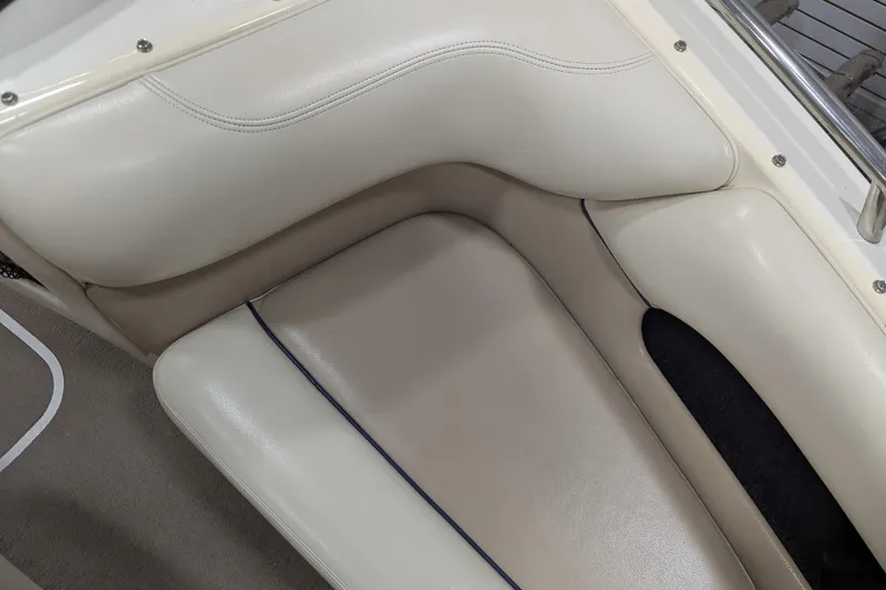 Slide: The Image of 1998 Malibu Sunsetter VLX boat interior with beige leather seating. - 13