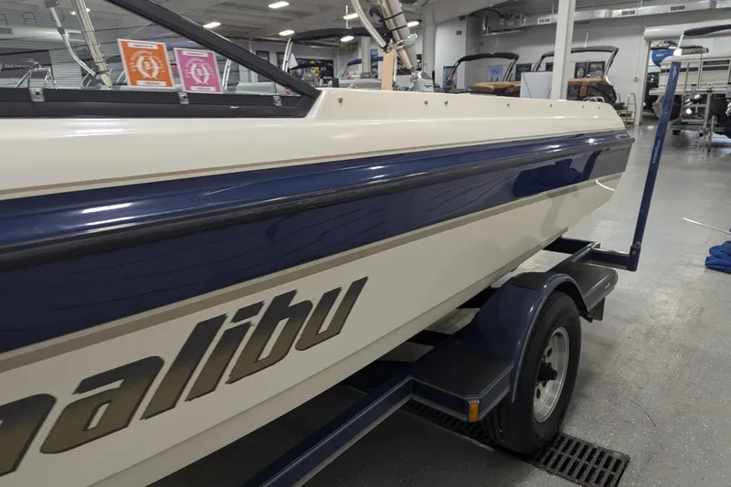 Slide: The Image of 1998 Malibu Sunsetter VLX boat on trailer in showroom, side view. - 15
