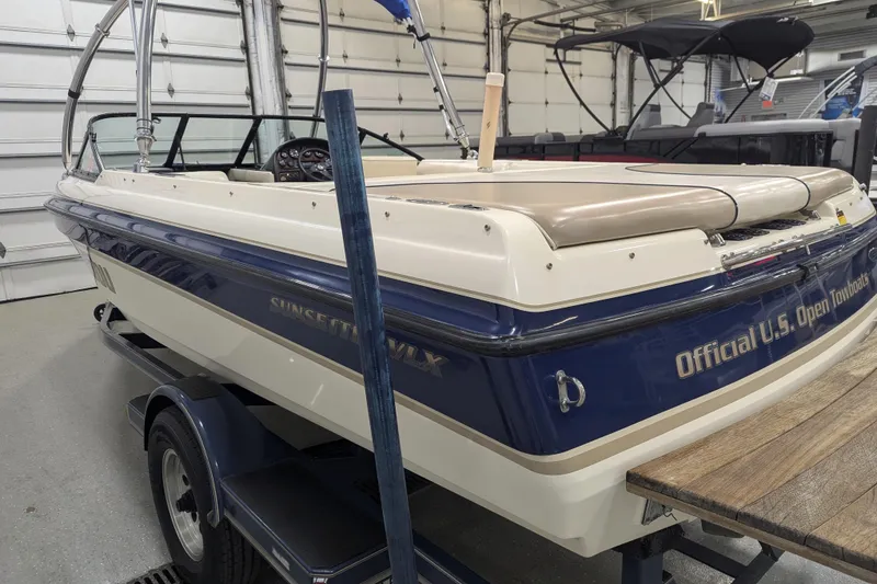 Slide: The Image of 1998 Malibu Sunsetter VLX boat in garage, blue and white, "Official U.S. Open Towboats" text. - 16