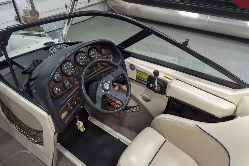 Slide: The Image of 1998 Malibu Sunsetter VLX boat interior with steering wheel and dashboard controls. - 18