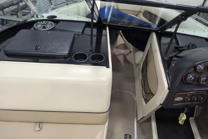 Slide: The Image of 1998 Malibu Sunsetter VLX boat interior with beige seating and dashboard controls. - 19