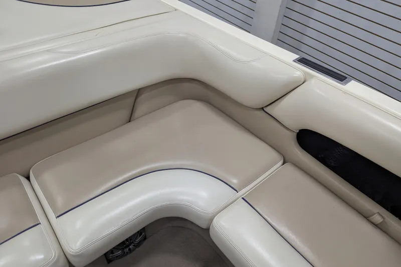 Slide: The Image of 1998 Malibu Sunsetter VLX boat interior with beige leather seating. - 21