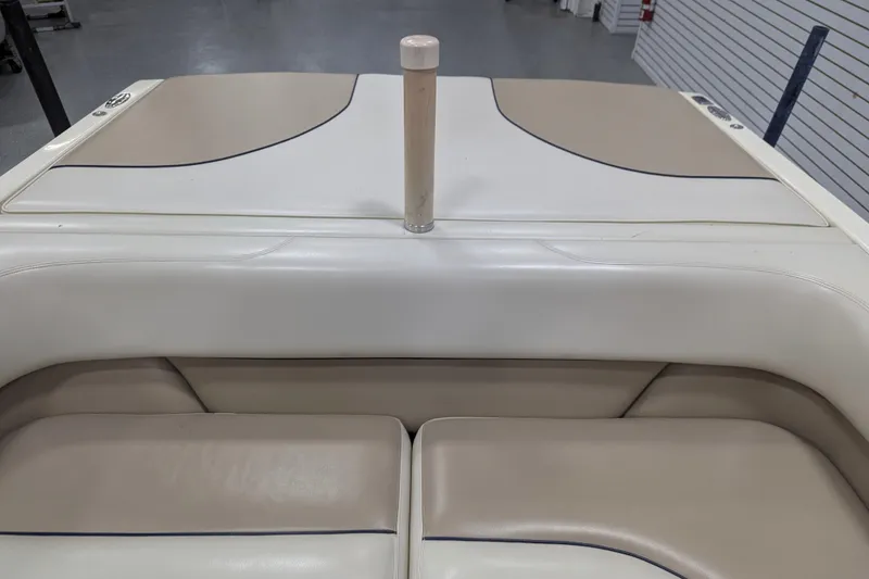 Slide: The Image of 1998 Malibu Sunsetter VLX boat interior with beige seating and sleek design. - 22