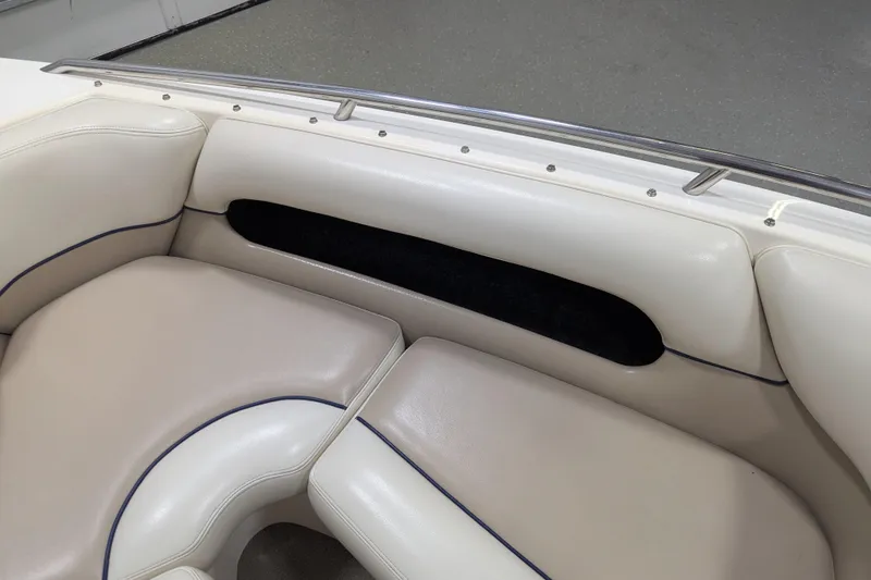 Slide: The Image of 1998 Malibu Sunsetter VLX boat interior with beige leather seating and blue trim. - 24