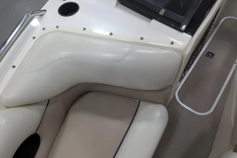 Slide: The Image of 1998 Malibu Sunsetter VLX boat interior with beige and white seating. - 25