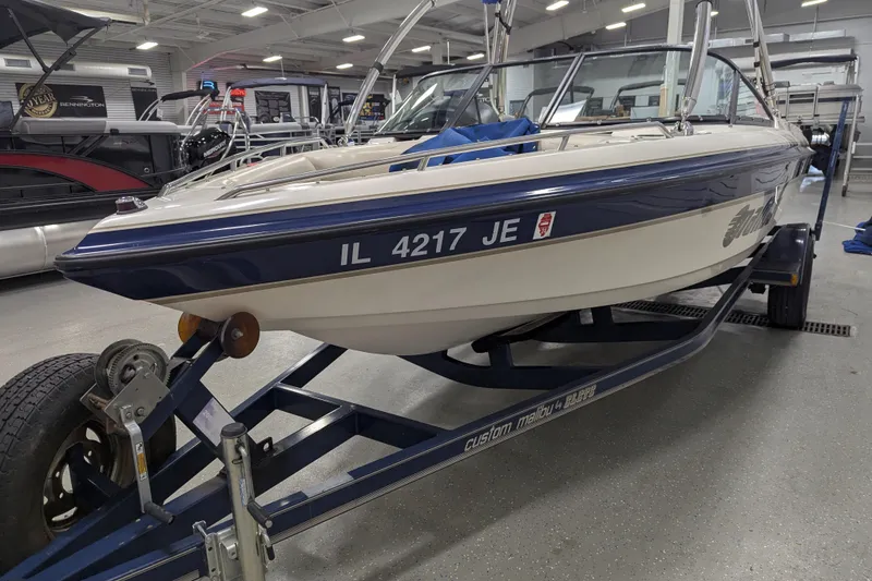 Slide: The Image of 1998 Malibu Sunsetter VLX boat on trailer in indoor showroom. - 7