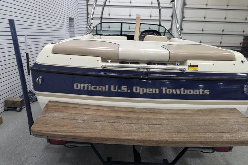 Slide: The Image of 1998 Malibu Sunsetter VLX boat, labeled "Official U.S. Open Towboats," in a garage setting. - 9