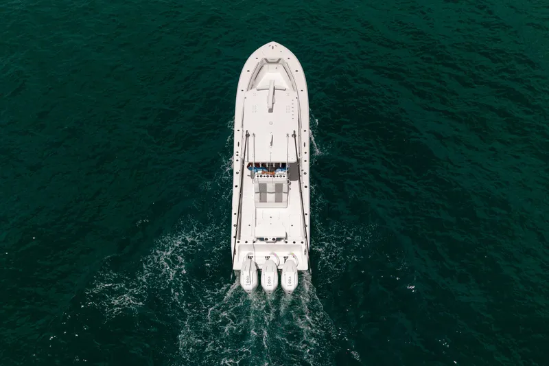 Slide: The Image of 2023 Invincible 36 Open Fisherman boat cruising on open water, aerial view. - 23
