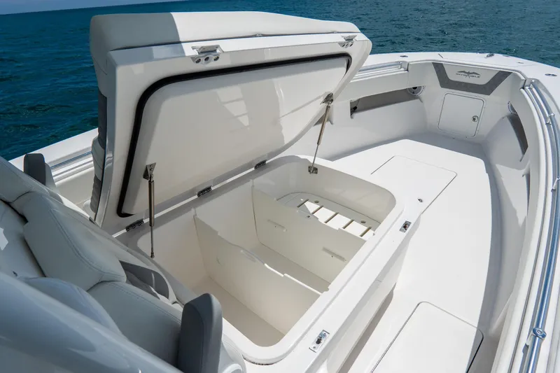 Slide: The Image of 2023 Invincible 36 Open Fisherman boat with open storage compartment, ocean backdrop. - 9