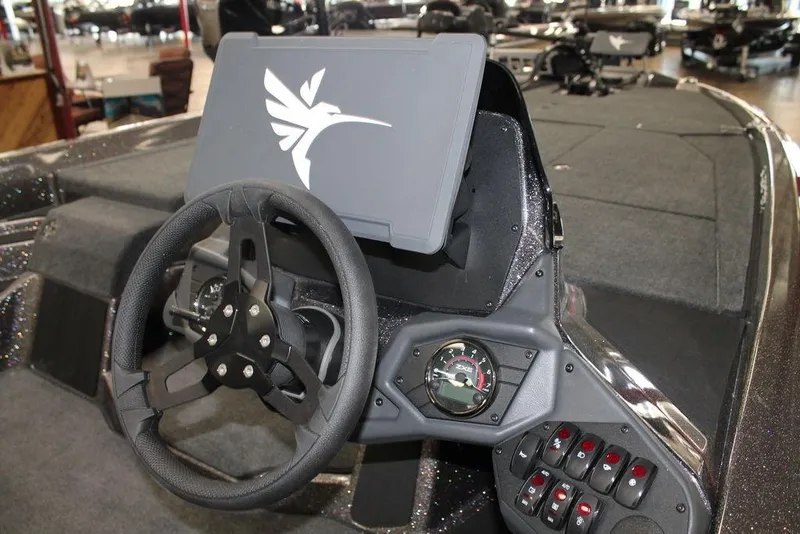 Slide: The Image of 2026 Skeeter ZXE21 boat dashboard with steering wheel and control panel. - 4