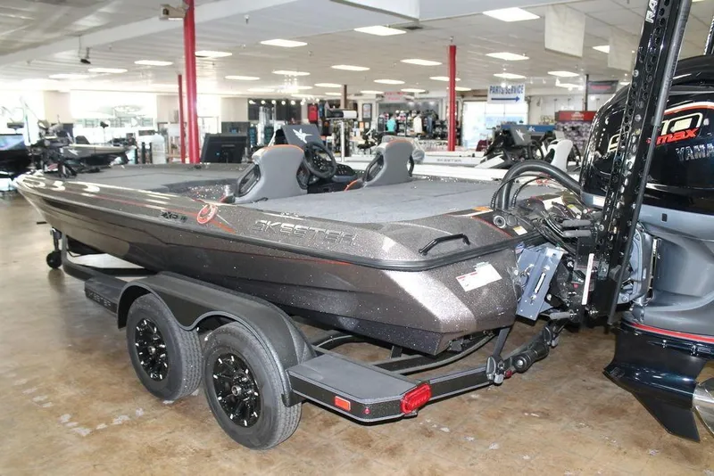 Slide: The Image of 2026 Skeeter ZXE21 boat in showroom, featuring sleek design and dual-axle trailer. - 7