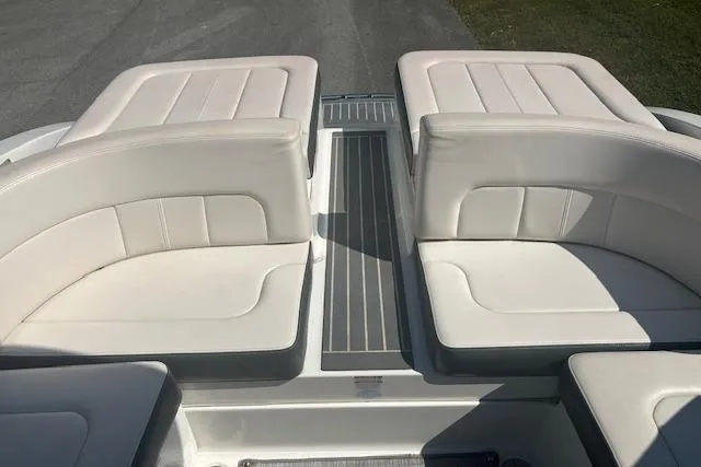 Slide: The Image of 2017 Chaparral 277 SSX boat interior with white cushioned seating and sleek design. - 7