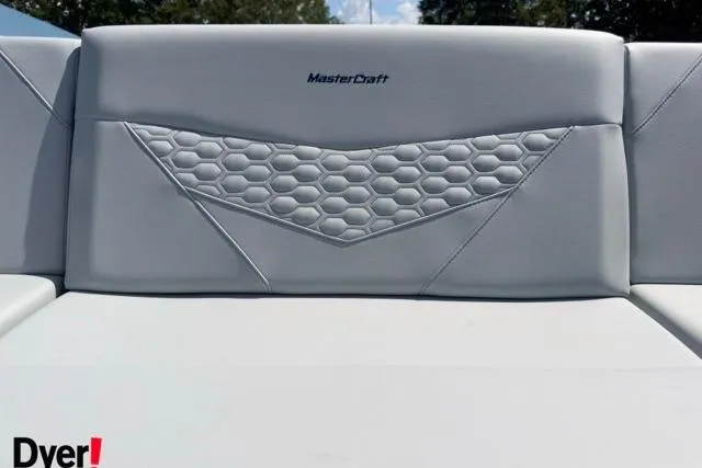 Slide: The Image of 2026 MasterCraft NXT22 boat seat with hexagonal pattern and logo detail. - 11
