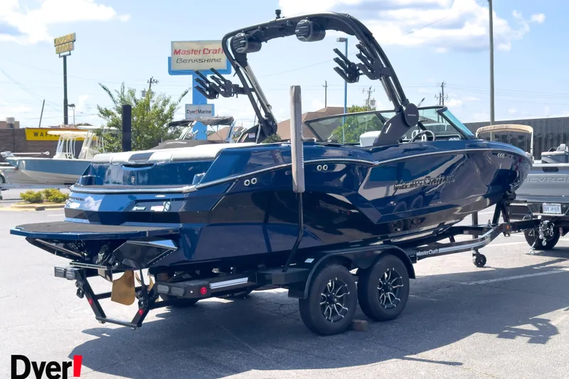 Slide: The Image of 2026 MasterCraft NXT22 boat on trailer, displayed outdoors at dealership. - 3