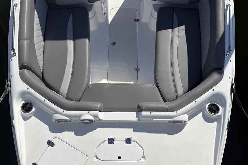Slide: The Image of 2026 NauticStar 223 DC Deck boat interior with gray seating and storage compartments. - 3