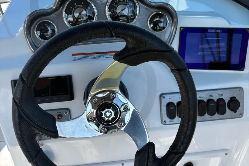 Slide: The Image of Steering wheel and dashboard of 2026 NauticStar 223 DC Deck boat. - 8