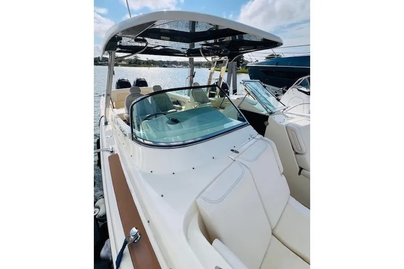 Slide: The Image of 2022 Chris-Craft Calypso 30 boat with sleek design, docked on a sunny day. - 15