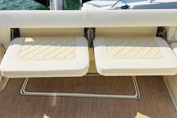 Slide: The Image of 2022 Chris-Craft Calypso 30 boat interior with cushioned seating and elegant design. - 21