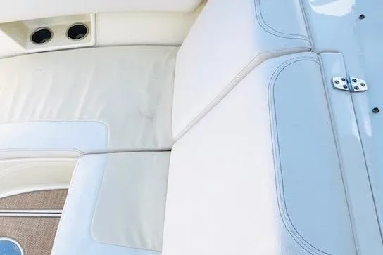 Slide: The Image of 2022 Chris-Craft Calypso 30 boat interior with white leather seating and cup holders. - 23
