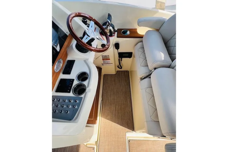 Slide: The Image of 2022 Chris-Craft Calypso 30 helm with luxurious seating and elegant wood accents. - 25