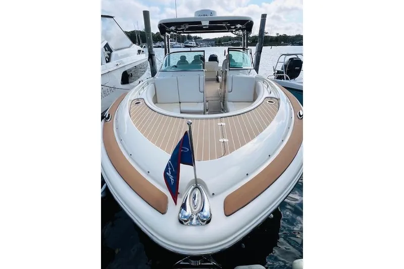 Slide: The Image of 2022 Chris-Craft Calypso 30 boat docked, featuring elegant deck design and seating. - 3