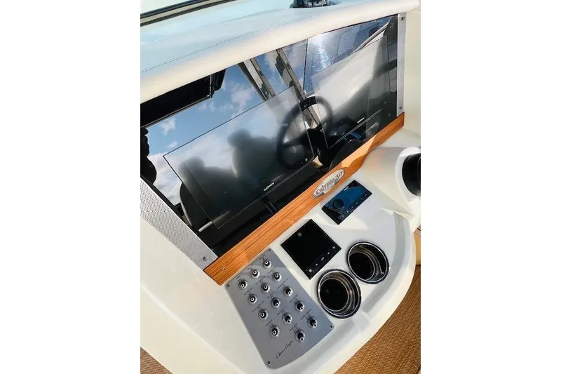 Slide: The Image of 2022 Chris-Craft Calypso 30 dashboard with modern controls and navigation screens. - 30