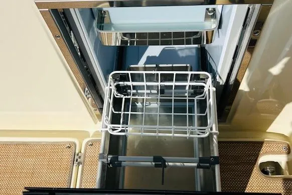 Slide: The Image of 2022 Chris-Craft Calypso 30 boat refrigerator with open drawer and wire basket. - 38