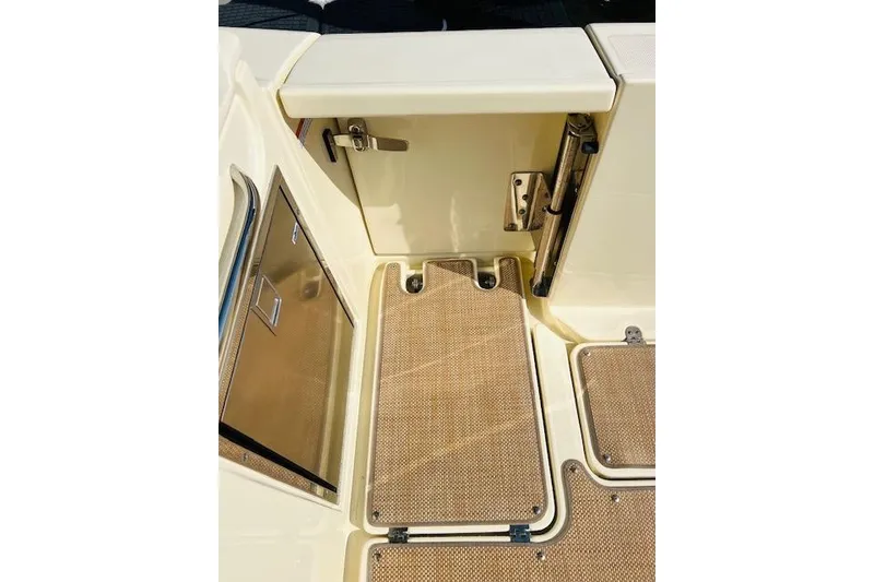 Slide: The Image of 2022 Chris-Craft Calypso 30 boat deck with beige flooring and stainless steel accents. - 39