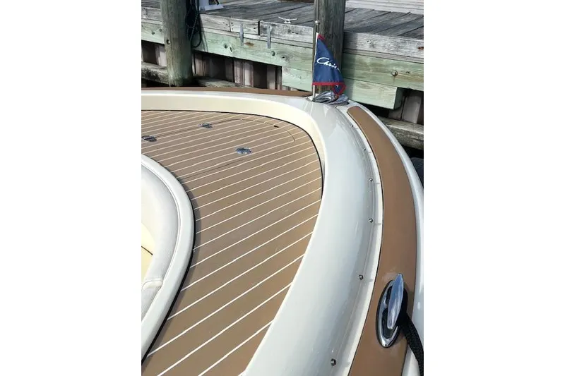 Slide: The Image of 2022 Chris-Craft Calypso 30 boat deck with wood finish and flag detail. - 4