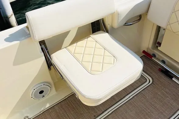 Slide: The Image of 2022 Chris-Craft Calypso 30 boat seat with quilted cushion and beige flooring. - 43