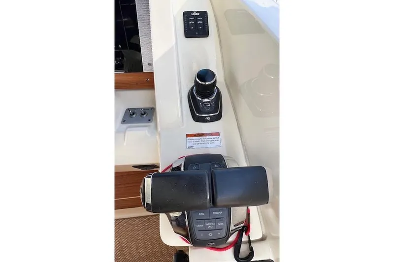 Slide: The Image of Control panel of 2022 Chris-Craft Calypso 30 boat, featuring joystick and throttle controls. - 45