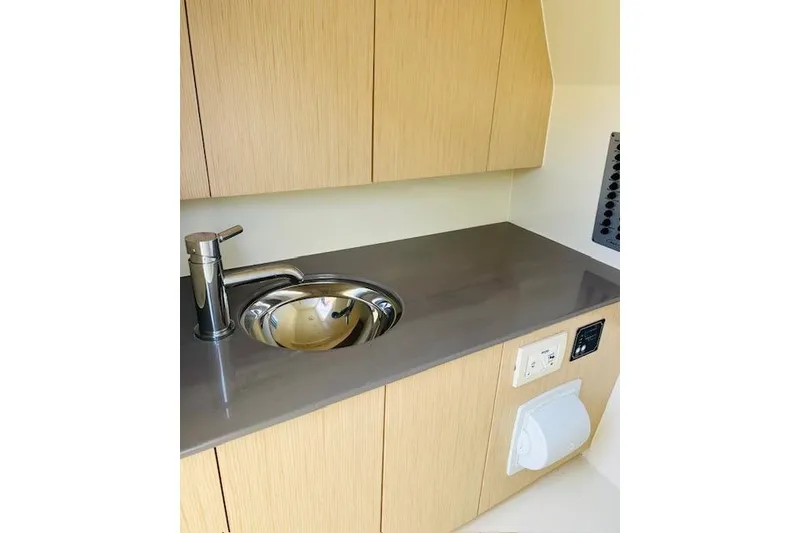 Slide: The Image of 2022 Chris-Craft Calypso 30 interior with modern sink and cabinetry. - 46