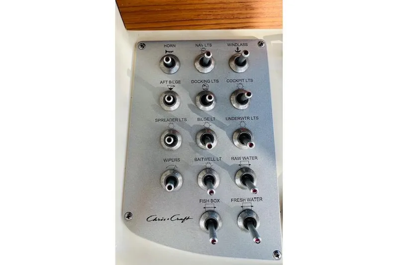 Slide: The Image of Control panel of 2022 Chris-Craft Calypso 30 boat with labeled switches. - 47