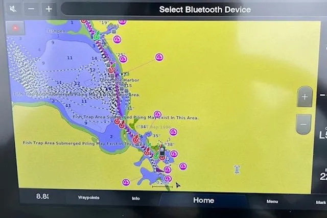 Slide: The Image of Navigation screen on 2022 Chris-Craft Calypso 30, displaying marine chart and Bluetooth options. - 50