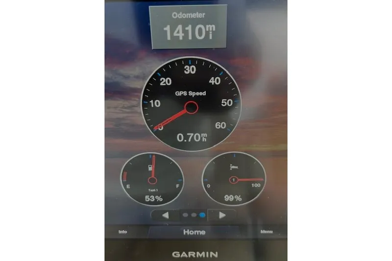 Slide: The Image of Garmin display showing GPS speed, odometer, and fuel levels on 2022 Chris-Craft Calypso 30. - 51