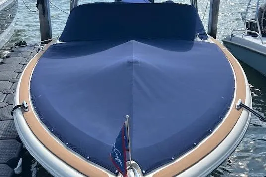 Slide: The Image of 2022 Chris-Craft Calypso 30 boat with blue cover docked at marina. - 9